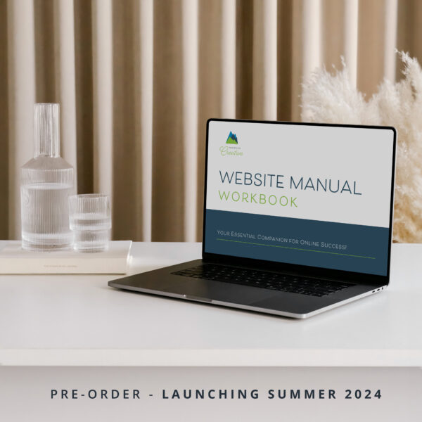 Laptop displaying a Website Manual Workbook (Pre-Order) advertisement on a desk, with a tagline for pre-order and a summer 2024 launch.