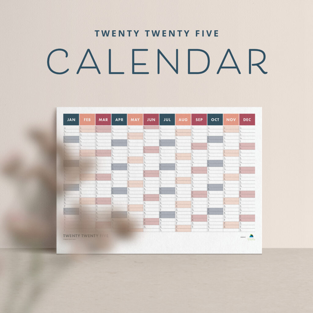 A 2025 wall calendar elegantly showcases months and days, with a blurred plant adding depth in the foreground—a perfect blend of function and style, ideal for promotion.